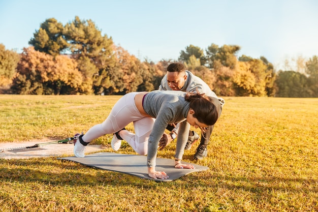 Personal trainer training a girl on the outside