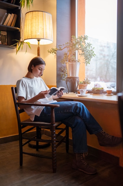 Persoon in een café die geniet van een boek