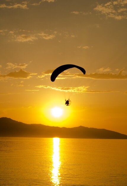 Foto persoon paragliden over zee tegen de lucht