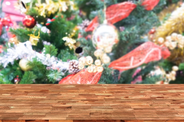 Perspective empty wooden table and christmas tree blur decoration background, for product 