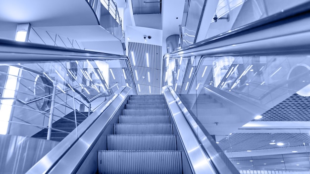 Photo perspective of escalator toned in blue color