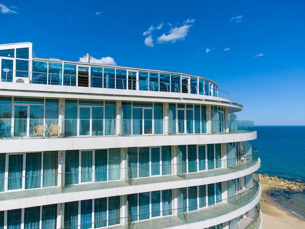 Perspective of highrise condominium building with sea view background