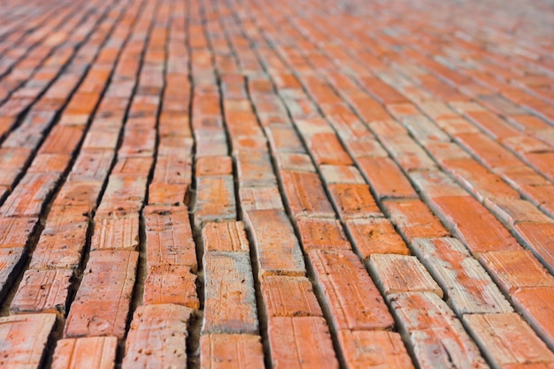 The perspective of a red brick walk focuses on  1 part 3 in front.