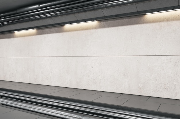 Perspective view on blank light grey wall for advertising\
billboard behind rails in abstract empty underground area with\
lights on top 3d rendering mockup