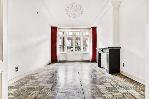 Perspective view of empty classic style room interior with white stucco elements and tiled floor with large window and fireplace