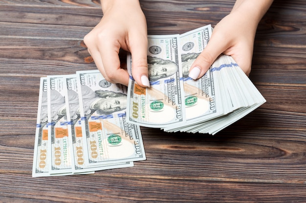 Perspective view of female hands counting money