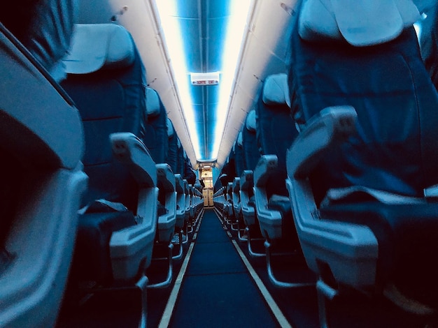 Foto vista prospettica del corridoio interno dell'aereo in luce blu