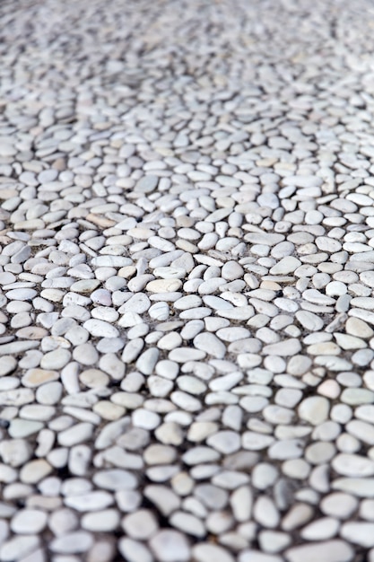 Perspective view at small round stones in the concrete wall