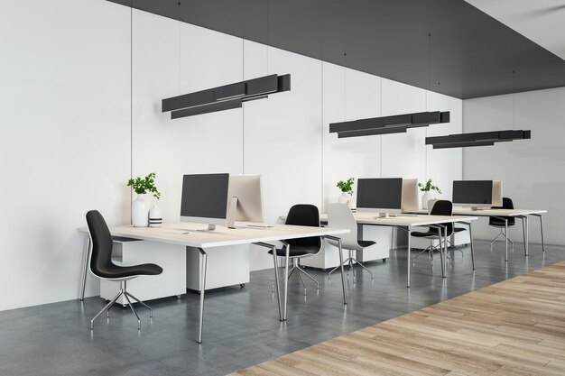 Perspective view on stylish coworking office work places with modern computers on light tables black lamps and chairs on dark concrete and wooden floor 3D rendering