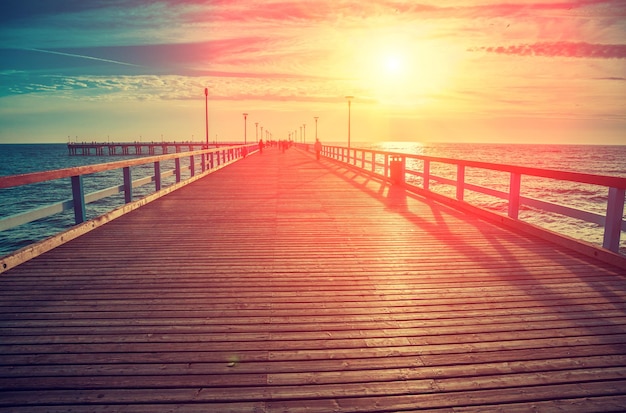 Perspective view of wooden pier over sea Palanga city at sunset in autumn Lithuania