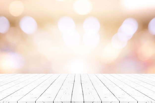 Perspective white wooden table on top over blur natural background.