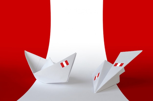 Peru flag depicted on paper origami airplane and boat. Handmade arts concept background