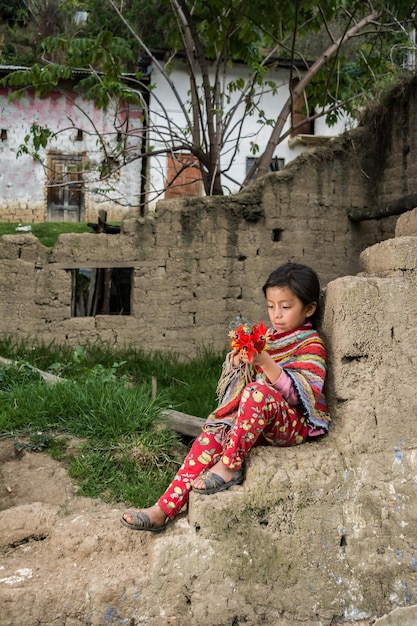 Peruvian Andean girls making weavings and posing in in their town and homes with colored clothes