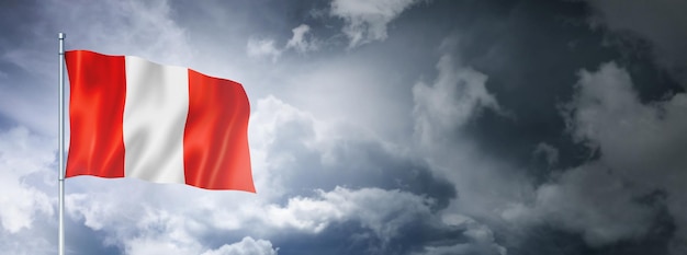 Peruvian flag on a cloudy sky