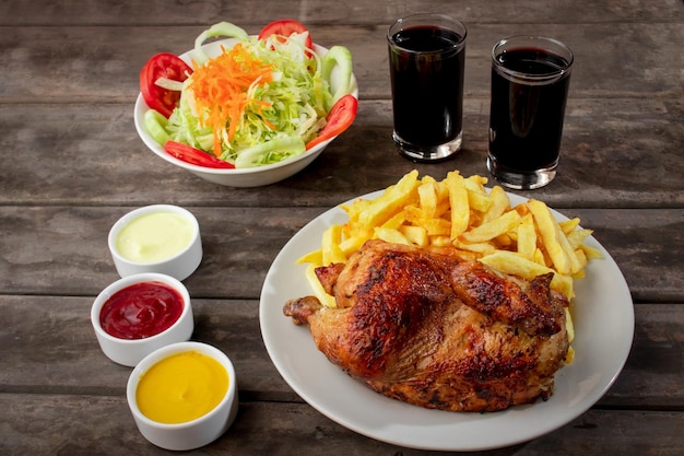 Peruvian food called pollo a la brasa with salad and french fries