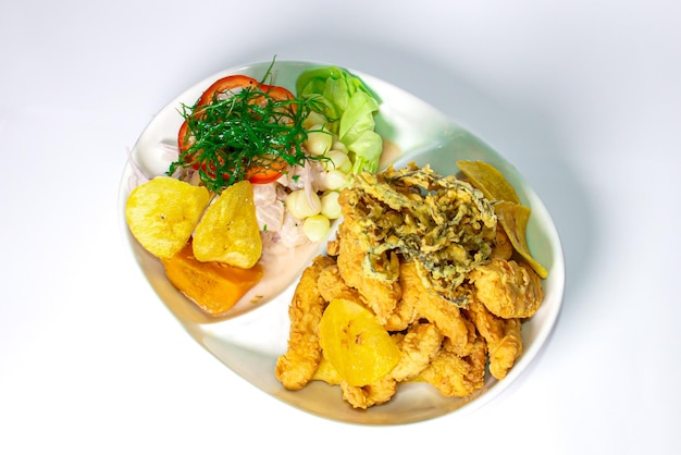 Peruvian food CEVICHE CON CHICHARRN DE PESCADO a traditional Peruvian dish marine duo