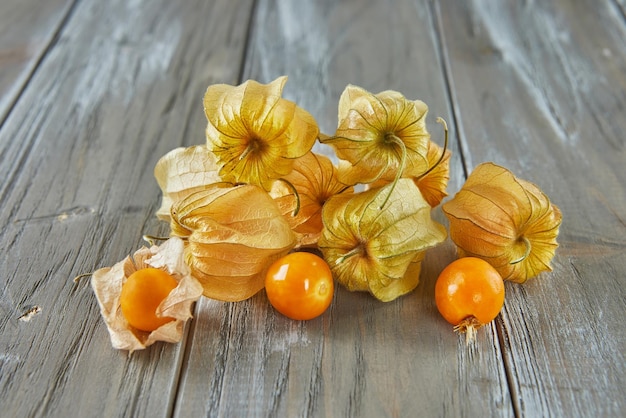 Peruvian physalis Cape gooseberry Fresh peachberry very tasty and healthy berries on a wooden table