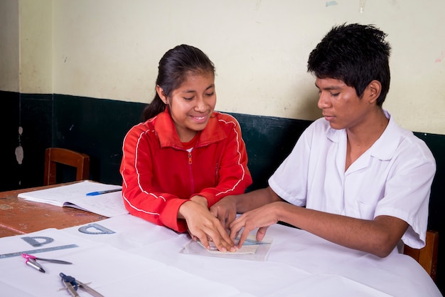 Peruvian South American schoolchildren posing alone and with their teachers performing tasks