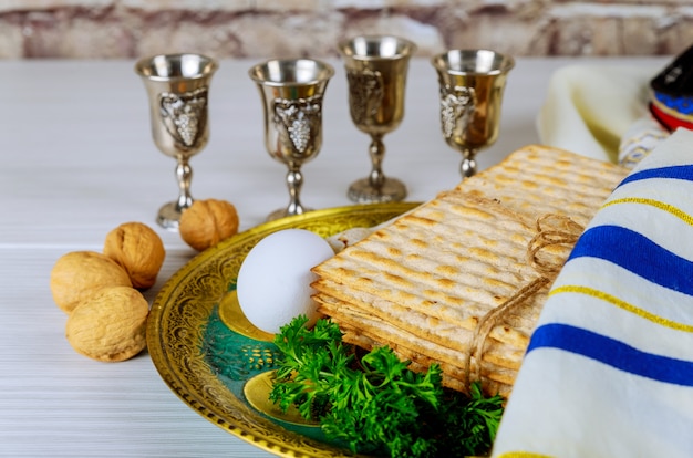 Pesach Passover symbols of great Jewish holiday. Traditional matzo and wine in vintage silver glass.