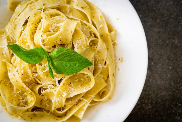 pesto fettuccine pasta with parmesan cheese on top - Italian food style