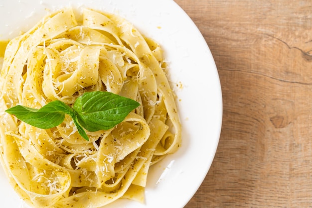 pesto fettuccine pasta with parmesan cheese on top - Italian food style