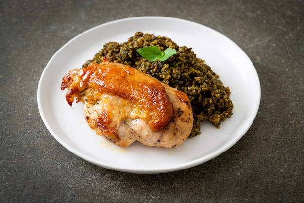 pesto fried rice with grilled chicken on white plate