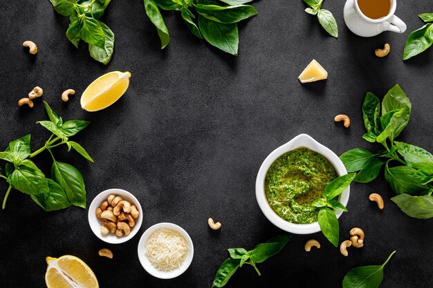 Pesto kale with ingredient for cooking on home kitchen table top viewxA