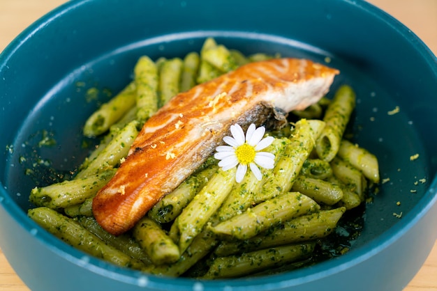 Pesto penne pasta with grilled salmon