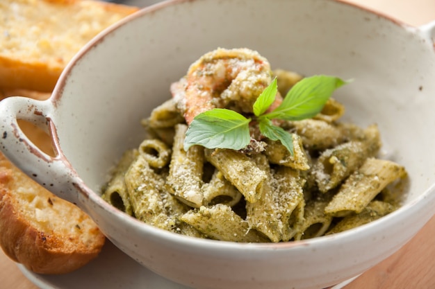 Pesto penne pasta with shrimp and garlic bread