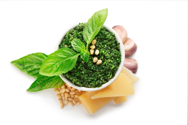 Pesto sauce isolated on white background with ingredients.