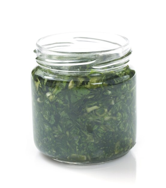 Pesto sauce in jar isolated on white