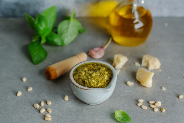 Pesto sauce in small bowl on table. Closeup