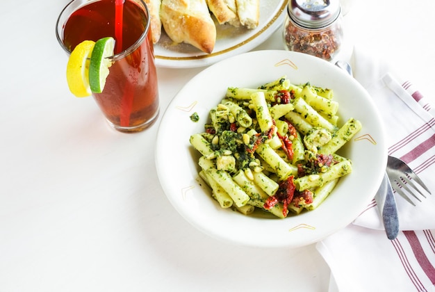 Pesto ziti with chicken in the plate in Italian restaurant.