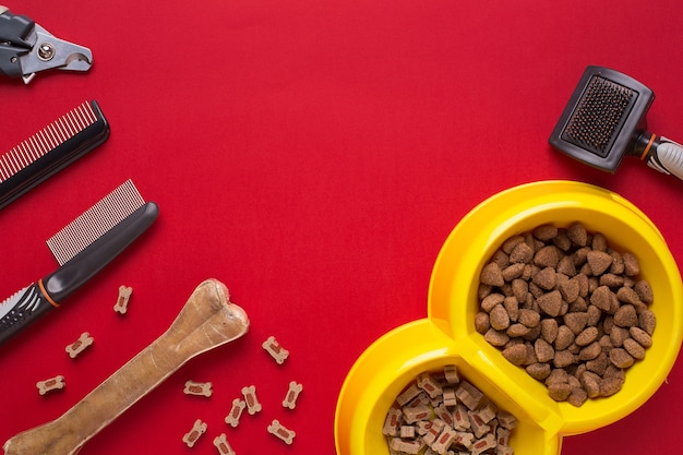 Photo pet accessories on red background. top view. still life. copy space