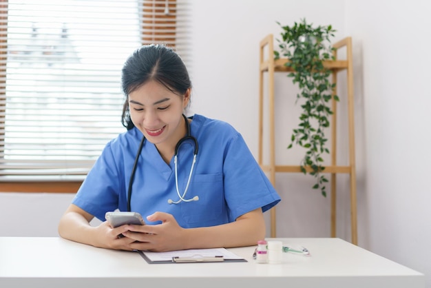 Concetto di cura degli animali veterinario femminile che utilizza lo smartphone per rilassarsi dopo aver esaminato l'animale domestico sano