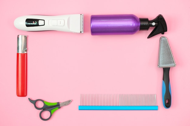 Pet care and grooming tools on a pink background. pet care and hygiene concept. Copy space, place for your text. mock up