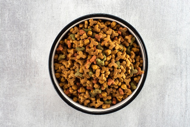 Pet food in a bowl on a gray surface