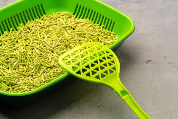 Pet litter tray with wooden filler on gray background