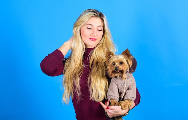 Pet supplies Dressing dog for cold weather Which dog breeds should wear coats Woman carry yorkshire terrier Dogs need clothes Girl adorable blonde hug little dog in coat Apparel and accessories