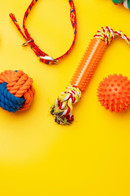 Pet toys on yellow background studio shot