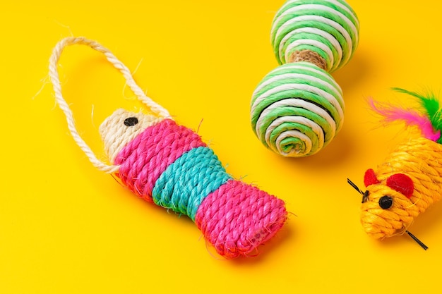 Pet toys on yellow background studio shot