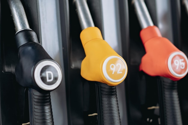 Photo petrol pump filling fuel nozzles at gas station