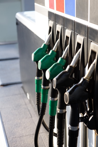 Petrol pump filling nozzles, gas station in a service