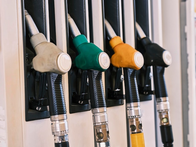 Petrol pump filling nozzles, Gas station in a service.