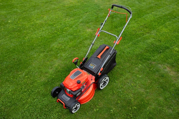 Petrol selfpropelled lawn mower on green grass