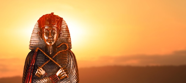 Pharaoh statue against the sky at sunset