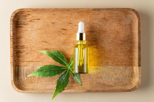 Pharmaceutical CBD oil and cannabis tincture on a wooden background. The concept of medical marijuana and alternative medicine. Organic cosmetics top view.