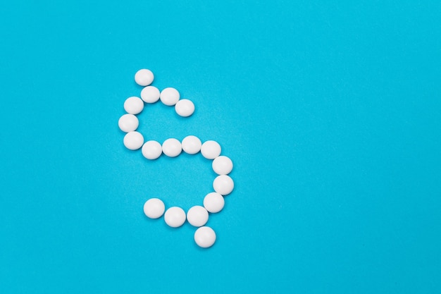 Pharmaceutical industry and business  dollar symbol made from white pills