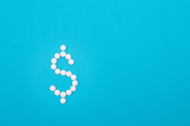 Pharmaceutical industry and business  dollar symbol made from white pills