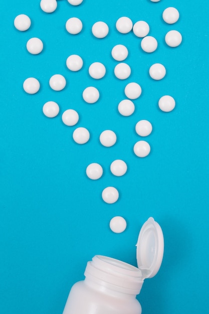 Pharmaceutical industry and medicinal products  white pills on blue background